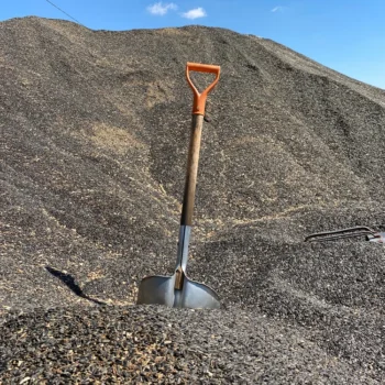 Shovel in a mountain of aggregates